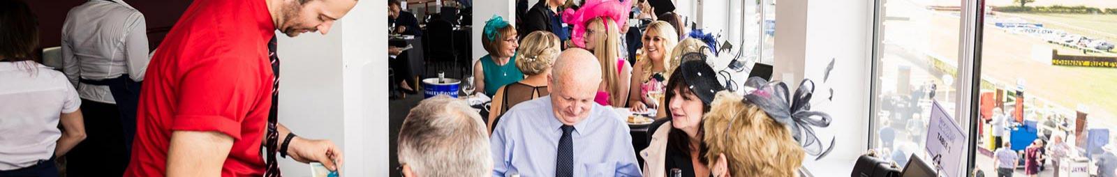 Crowds sitting inside a restaurant at Sedgefield Racecourse.